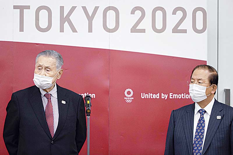 TOKYO: Tokyo Olympic and Paralympic Games Organizing Committee (TOGOC) president Yoshiro Mori (left) and CEO Toshiro Muto speak to the media after their video conference with IOC president Thomas Bach yesterday. - AFP n