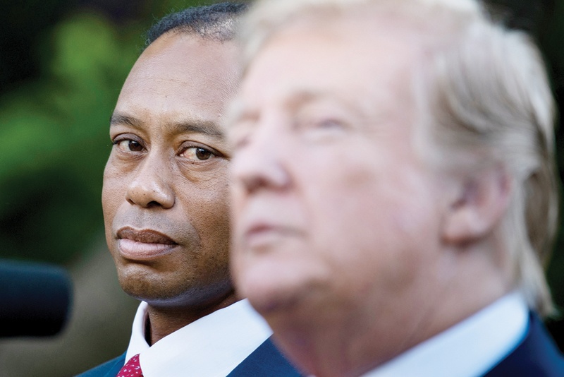 WASHINGTON: In this file photo professional golfer Tiger Woods listens while US President Donald Trump speaks during a Presidential Medal of Freedom ceremony in the Rose Garden of the White House May 6, 2019, in Washington, DC. - AFPn
