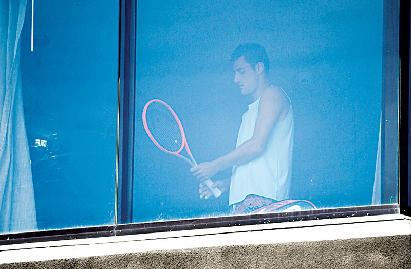 MELBOURNE: Australian tennis player Bernard Tomic exercises in his hotel room in Melbourne yesterday, as players quarantine in hotels ahead of the Australian Open tennis tournament. - AFPn