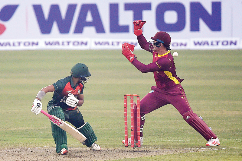 DHAKA: West Indies' Joshua Da Silva (R) tries to catch a ball during the first one-day international (ODI) cricket match between Bangladesh and West Indies at the Sher-e-Bangla National Cricket Stadium in Dhaka yesterday. - AFPn