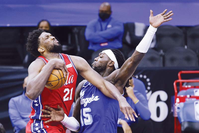 PHILADELPHIA: Joel Embiid #21 of the Philadelphia 76ers tries to drive past Montrezl Harrell #15 of the Los Angeles Lakers during the fourth quarter at Wells Fargo Center on Wednesday. - AFP  n