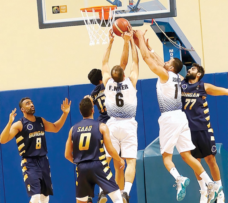 KUWAIT: Jahra and Burgan players vie for the rebound during their Kuwait Basketball League playoff match Sunday night.n