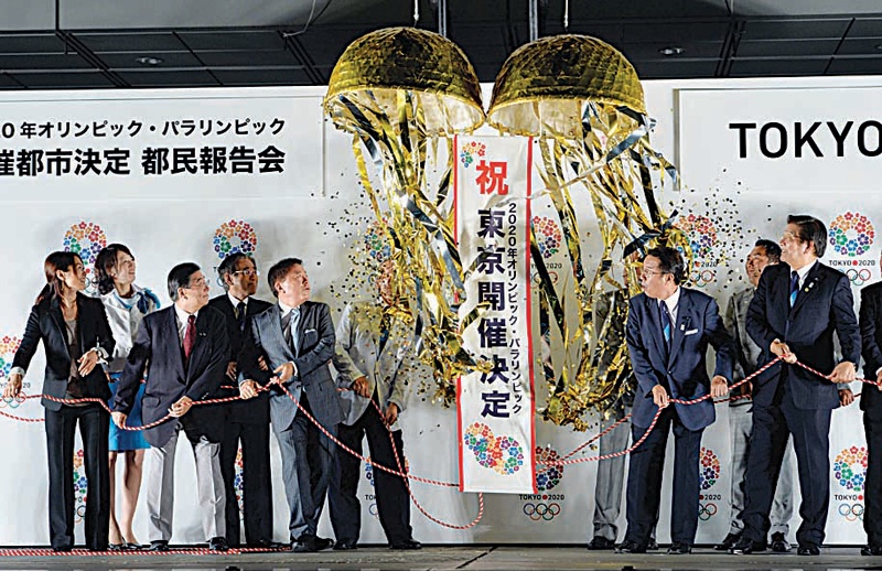 TOKYO: In this file photo taken on Sept 10, 2013 Tokyo Governor Naoki Inose, Tokyo 2020 bid committee members and Tokyo metropolitan assembly members open an ornamental ball to celebrate winning the right to host the 2020 Olympic Games at Tokyo city hall. - AFP  n