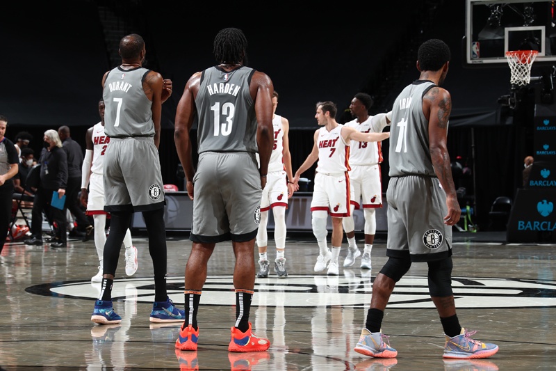 BROOKLYN: Kevin Durant #7, James Harden #13, and Kyrie Irving #11 of the Brooklyn Nets look on during the game against the Miami Heat on Monday at Barclays Center in Brooklyn, New York. - AFPn