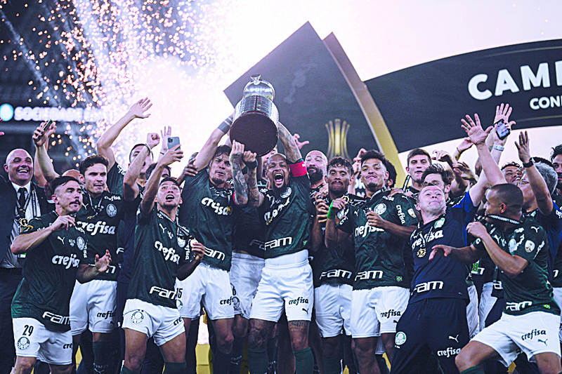 RIO DE JANEIRO: Players of Palmeiras celebrate with the trophy on the podium after winning the Copa Libertadores football tournament by defeating Santos 1-0 in the all-Brazilian final match at Maracana Stadium in Rio de Janeiro, Brazil, on Saturday. - AFPn