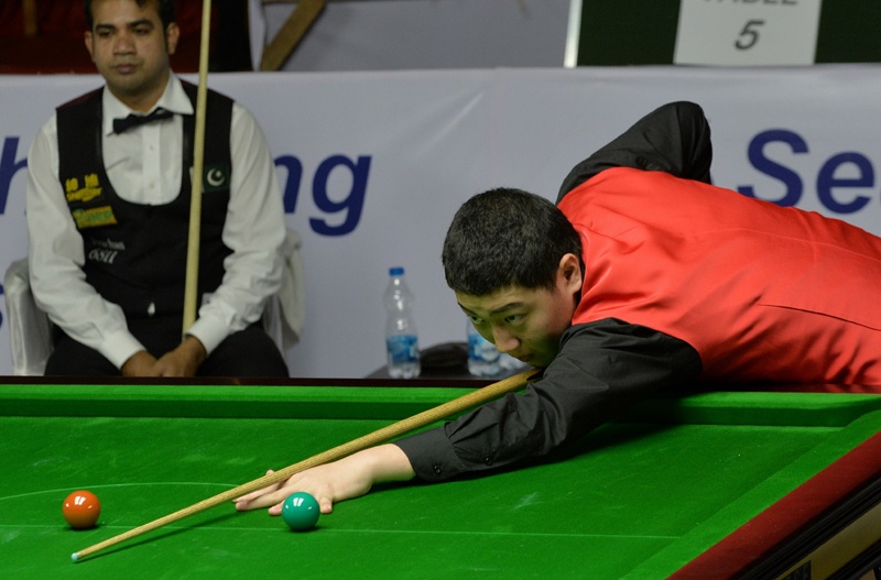 BANGALORE: This file photo taken on November 29, 2014 shows China's Yan Bingtao playing a shot against Pakistan cueist Mohammad Sajjad during the men's finals of the IBSF World Snooker Championship in Bangalore, India. – AFPn