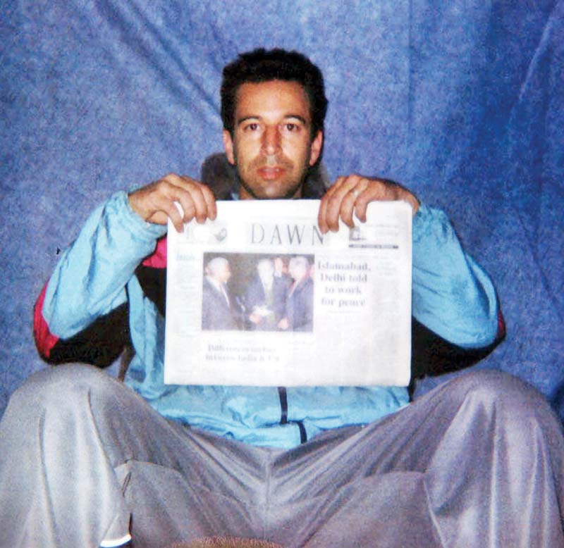 This undated file photo released by the Washington Post shows Wall Street Journal reporter Daniel Pearl at an undisclosed location with a copy of Pakistan's English language newspaper Dawn. - AFPn