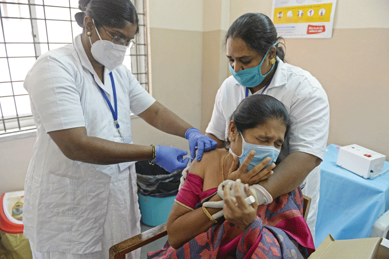 HYDERABAD: A member of medical staff reacts as a health worker inoculates her with a Covid-19 coronavirus vaccine at a government hospital in Hyderabad.-AFP n