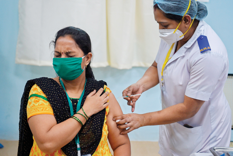 MUMBAI: A medical worker inoculates a colleague with a Covid-19 coronavirus vaccine at the Rajawadi Hospital in Mumbai.-AFP n