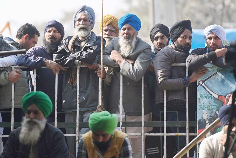 NEW DELHI: Farmers listen to a speaker during a protest against the central government's recent agricultural reforms, at the Delhi-Haryana state border in Singhu on Wednesday.-AFPn
