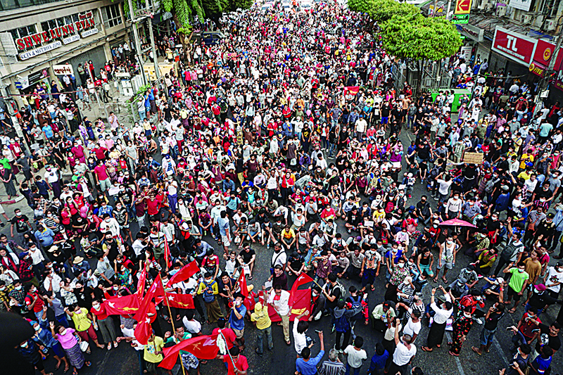 YANGON: Protesters take part in a demonstration against the military coup in Yangon yesterday. —AFP
