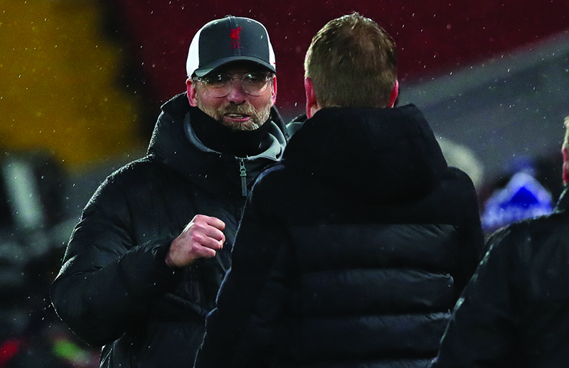 LIVERPOOL: Liverpool’s German manager Jurgen Klopp (left) congratulates Brighton’s English manager Graham Potter after the English Premier League football match between Liverpool and Brighton and Hove Albion at Anfield in Liverpool, north west England on February 3, 2021. Brighton won the match 1-0. — AFP