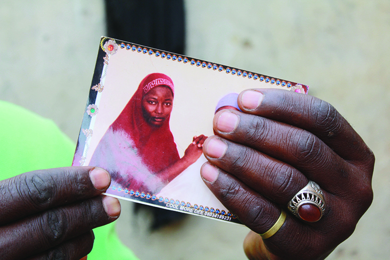 CHIBOK, Nigeria: In this file photo taken on April 12, 2019 Musa Maina holds a picture of her kidnapped daughter, Hauwa, in Chibok. — AFP