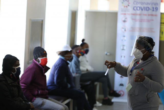 SOWETO: A medical worker gestures as she addresses some of the first South African Oxford vaccine trialist waiting ahead of the clinical trial for a potential vaccine against the COVID-19 coronavirus at the Baragwanath hospital in Soweto, South Africa.—AFPn
