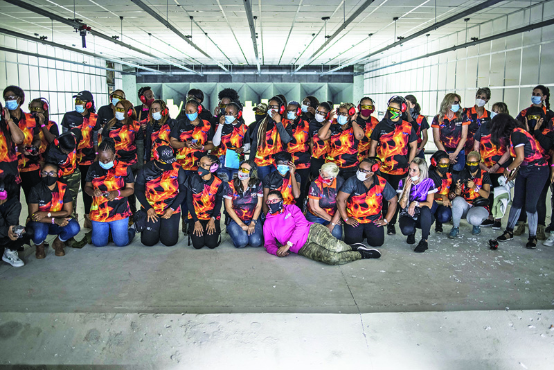 MIDRAND: Participants, fire range officers and instructors pose for a group photograph during a training organized by the women empowerment group Girls on Fire, in Midrand, on Sunday. - AFPn