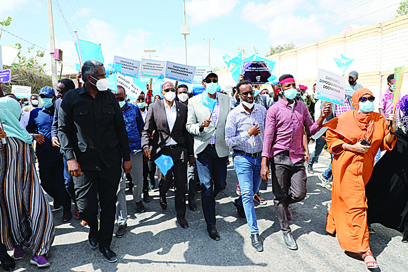 MOGADISHU: Supporters of different opposition presidential candidates demonstrate in Mogadishu on Friday. - AFPn n