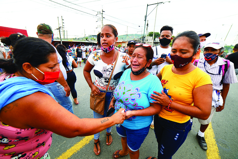 GUAYAQUIL, Ecuador:  Relatives of the prisoners at the Zone 8 Deprivation of Liberty Center are seen as they wait for news, in Guayaquil, Ecuador. At least 50 inmates died in riots at three prisons in Ecuador on Tuesday, police said. -- AFPn