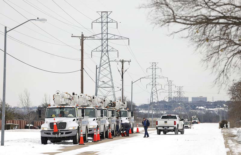 TEXAS: Pike Electric service trucks line up after a snow storm on Tuesday in Fort Worth, Texas.-AFP  n