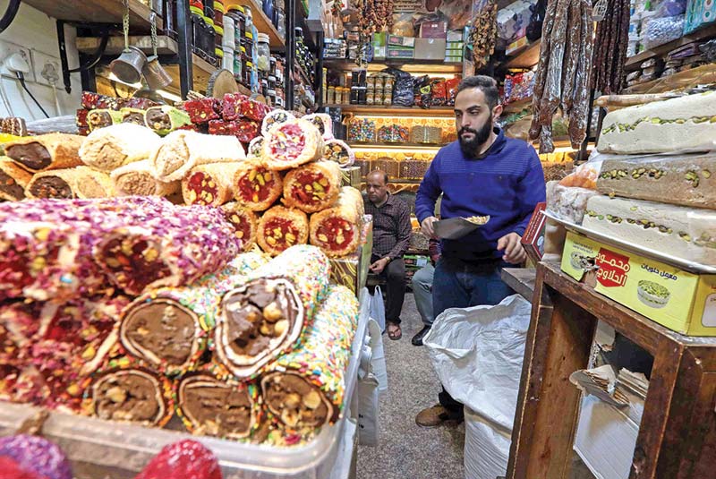 An Iraq man sells nuts in the old bazaar in Arbil, the capital of the northern Iraqi Kurdish autonomous region.-AFP photosn