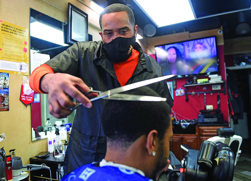 Mike Brown cuts the hair of Kendrick Furbush at The Shop Hair Spa in Hyattsville.n