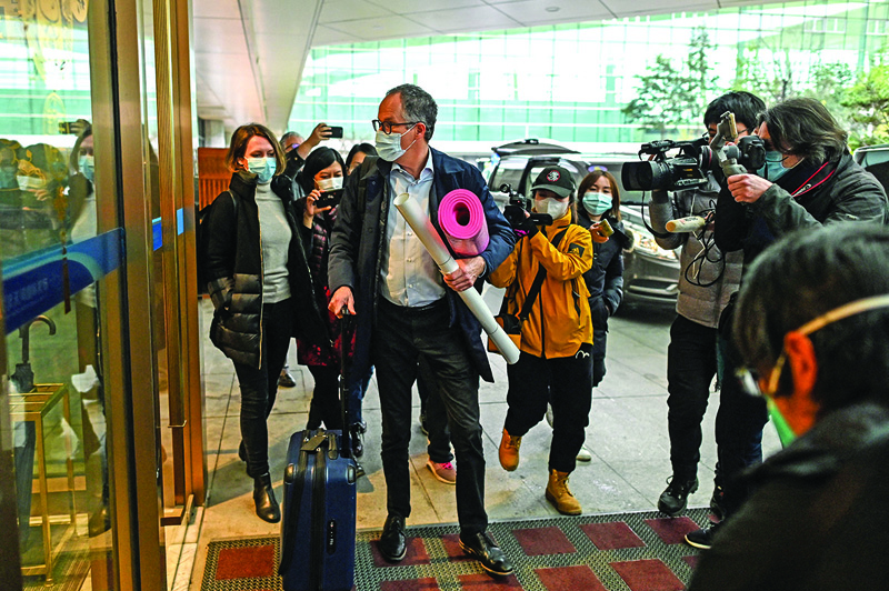 WUHAN, China : Tianhe WHO team member Peter Ben Embarek (center) and other members of the group arrive at Tianhe International Airport to leave Wuhan in China's central Hubei province yesterday, after the World Health Organization (WHO) team wrapped up its investigation into the origins of the COVID-19 coronavirus.-AFP nn