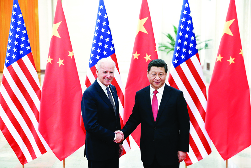 BEIJING: In this file photo taken on December 04, 2013 Chinese President Xi Jinping (right) shakes hands with US Vice President Joe Biden (left) inside the Great Hall of the People in Beijing. - AFPn