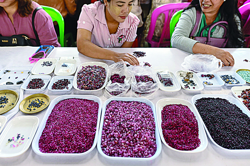 MOGOK, Myanmar: In this file photo sellers trade rubies and other gemstones at the gems market in Mogok town, north of Mandalay.ÑAFP n