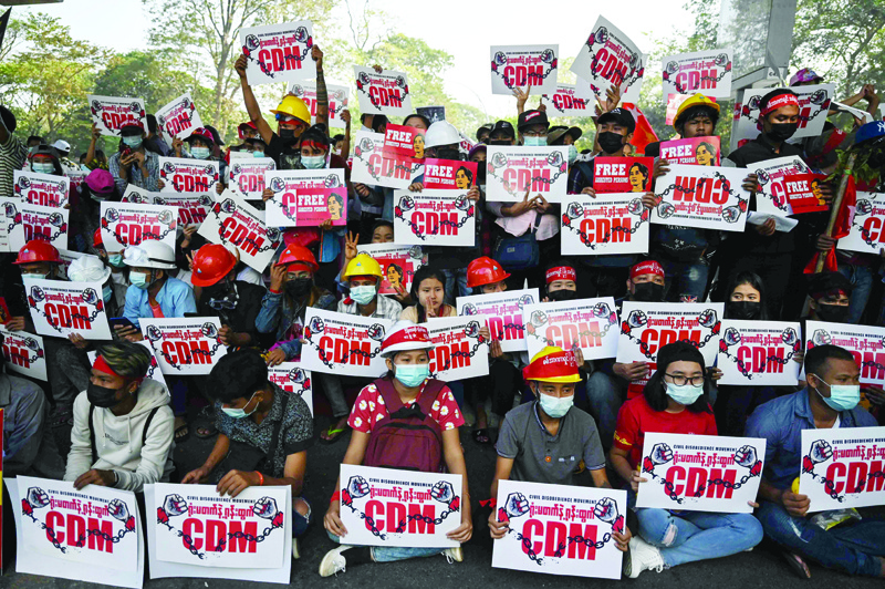 YANGON, Myanmar: Protesters hold up signs supporting the Civil Disobedience Movement (CDM) at a demonstration against the military coup in Yangon yesterday.-AFPn