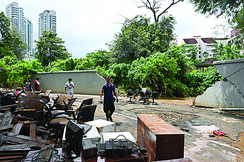 JAKARTA: People put out furniture to dry in the sun next to a wall where the Krukut river broke through and flooded the area in Kemang in Jakarta yesterday, a day after parts of Indonesia's capital were inundated with flooding from seasonal heavy rains.-AFP tn