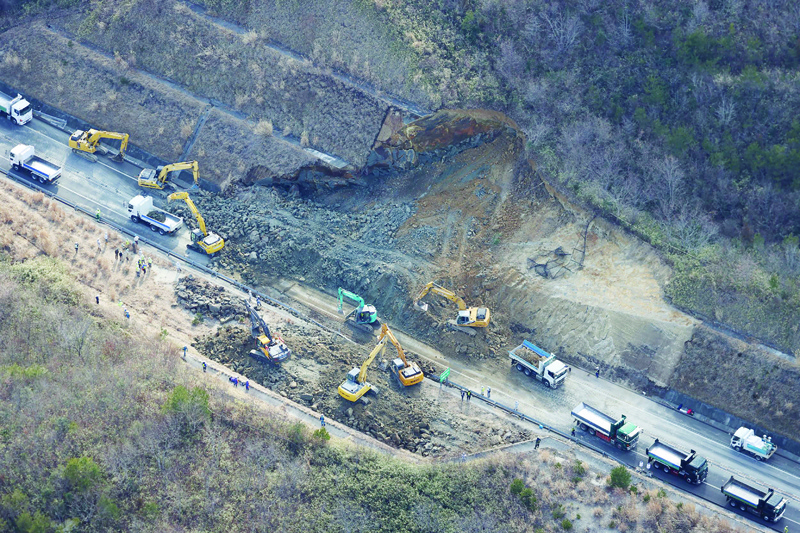 SOMA, Japan: This aerial picture taken from a Jiji Press chartered aircraft shows the landslide site on the Joban Expressway in Soma, Fukushima prefecture yesterday after a 7.3-magnitude earthquake struck off Japan's east coast.-AFP n