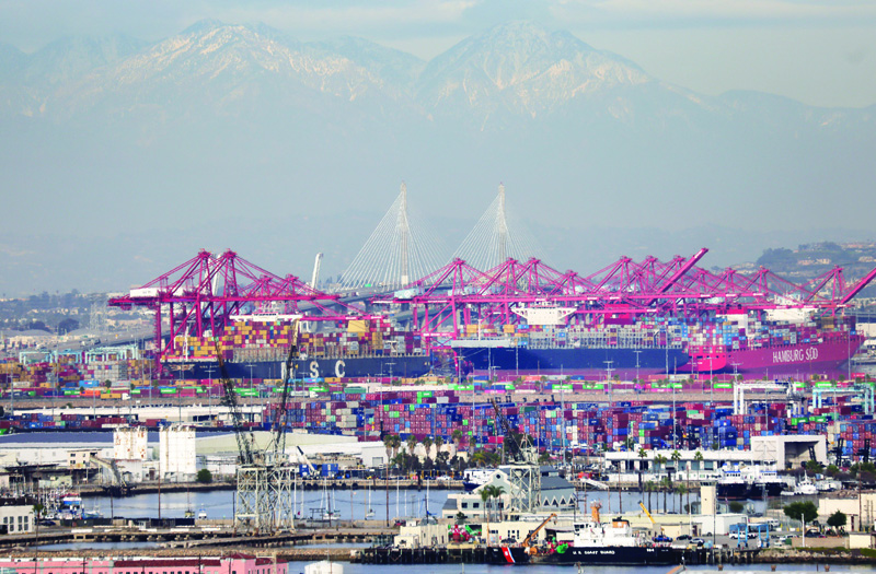 SAN PEDRO, California: Container ships and shipping containers (center) are viewed at the Port of Los Angeles with the Port of Long Beach in the distance in San Pedro, California. - AFPn