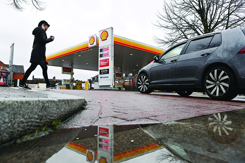 LONDON: In this file photo, a Shell service station is reflected in a puddle in London. Anglo-Dutch oil giant Shell will invest up to $6 billion (4.9 billion euros) per year in green energy after its oil output peaked in 2019, the group said yesterday.-AFPn
