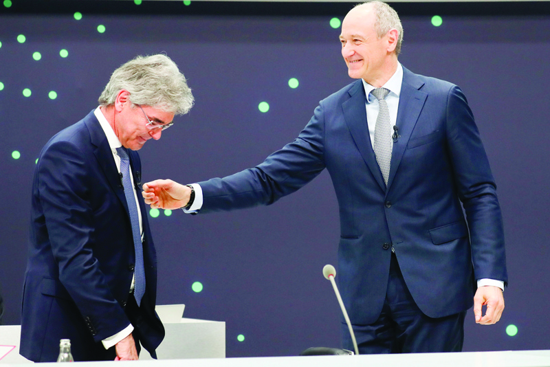 MUNICH: Outgoing CEO of German industrial conglomerate Siemens Joe Kaeser (left) and his successor Roland Busch react after his speech during the virtual annual shareholders' meeting in Munich, southern Germany, yesterday. - AFPn