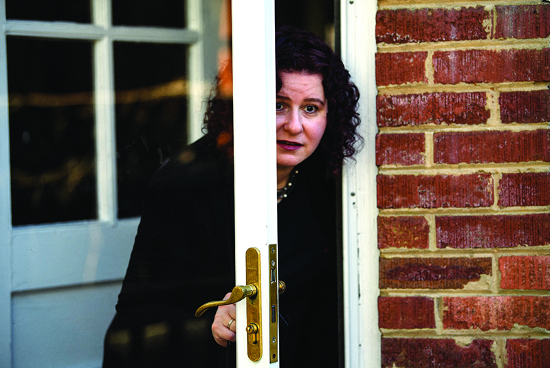 Allyson Kapin, General Partner at the W Fund and co-founder of Women Who Tech, peeks out of her back door before an interview with AFP in Washington, DC.-AFPn