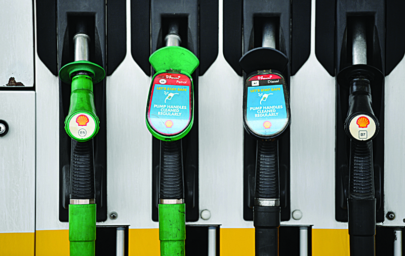LONDON: Logos are pictured on unleaded and diesel fuel pumps at a Shell petrol station in Etlham, southeast London. Royal Dutch Shell dived into a net loss of $21.7 billion in 2020, the oil giant announced yesterday  as the coronavirus pandemic slashed global energy demand. - AFPn