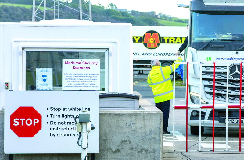 In this file photo taken on January 01, 2021 an official checks freight from Scotland as truckers disembark a ferry at the Port of Larne in County Antrim, Northern Ireland. - AFPn