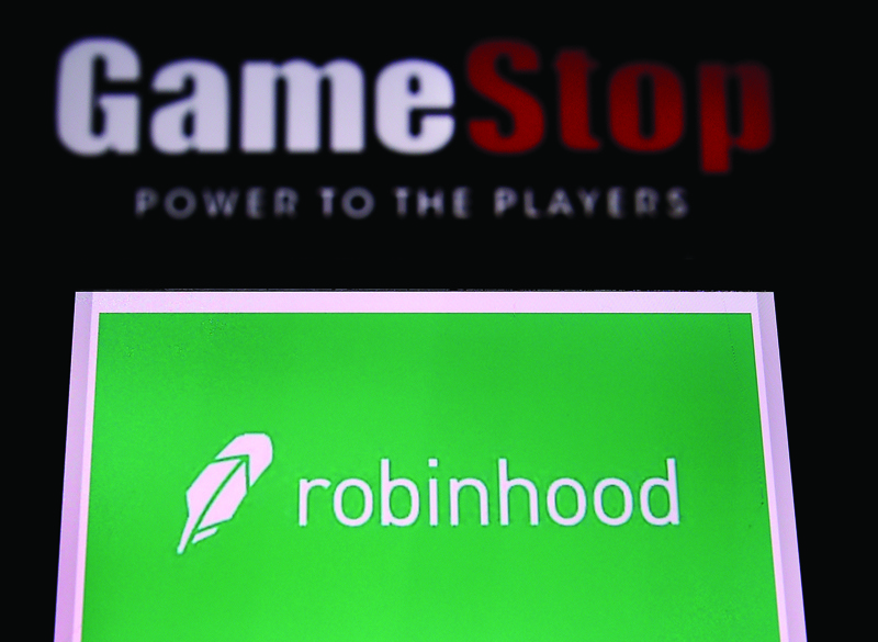 This file photo illustration shows the logos of video game retail store GameStop and trading application Robinhood in a computer and on a mobile phone in Arlington, Virginia. - AFPn