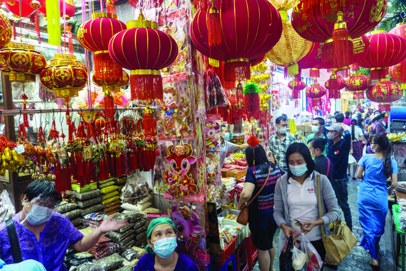 YANGON: People shop for Lunar New Year goodies in Chinatown in Yangon on Wednesday.-AFPn