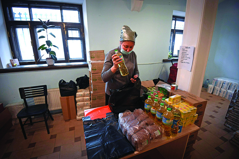 Moscow: A social worker at Miloserdie (Mercy), one of Russia's best known charities, prepares free food parcels at the Martha and Mary Convent in central Moscow.-AFP n