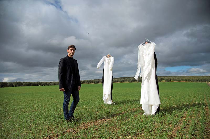 Spanish fashion designer Nicolas Montenegro poses with two of his creations at La Lantejuela, near Seville.-AFP photosn