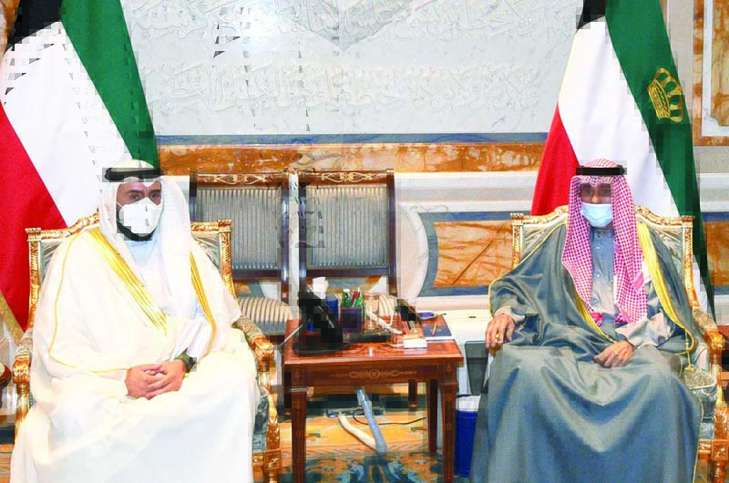 KUWAIT: HH the Amir Sheikh Nawaf Al-Ahmad Al-Jaber Al-Sabah receives Health Minister Sheikh Dr Basel Hmoud Al-Sabah at Bayan Palace yesterday. - KUNA n