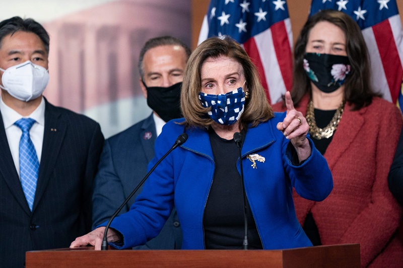 WASHINGTON: US Speaker of the House Nancy Pelosi, with House impeachment managers, speaks to the press at the US Capitol after the Senate voted to acquit former US President Donald Trump on Saturday. - AFP n