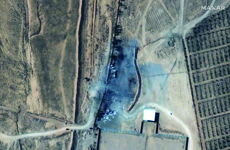 AL-QAIM, Iraq: This handout satellite image released on Friday shows the aftermath of recent US airstrikes on a small group of buildings at an unofficial crossing on the Syria-Iraq border. — AFP