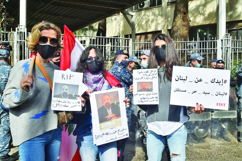 BEIRUT: Protesters hold pictures of slain prominent Lebanese activist and intellectual Lokman Slim, during a rally in front of the Justice Palace in the capital Beirut, yesterday.-AFPn