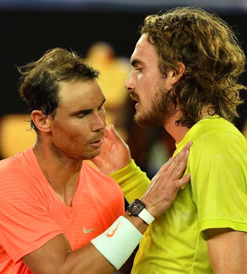 MELBOURNE: Greece's Stefanos Tsitsipas (right) and Spain's Rafael Nadal greet each other after their men's singles quarter-final match on day ten of the Australian Open tennis tournament in Melbourne yesterday. - AFPn