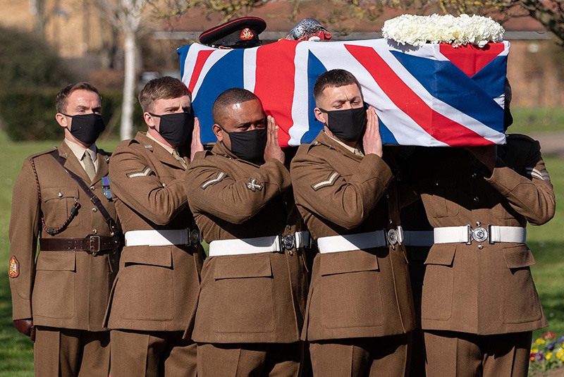 BEDFORD: Soldiers from the British Army's Yorkshire Regiment carry the coffin of Captain Tom Moore during his funeral service at Bedford Crematorium yesterday. — AFP n