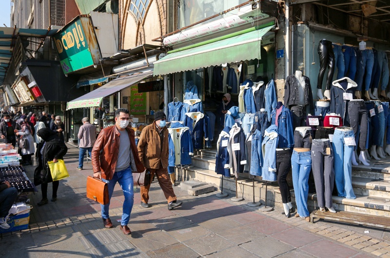 TEHRAN: Iranians wearing masks amid the COVID-19 pandemic walk on a market street in the capital in this Dec 30, 2020 photo. – AFP n