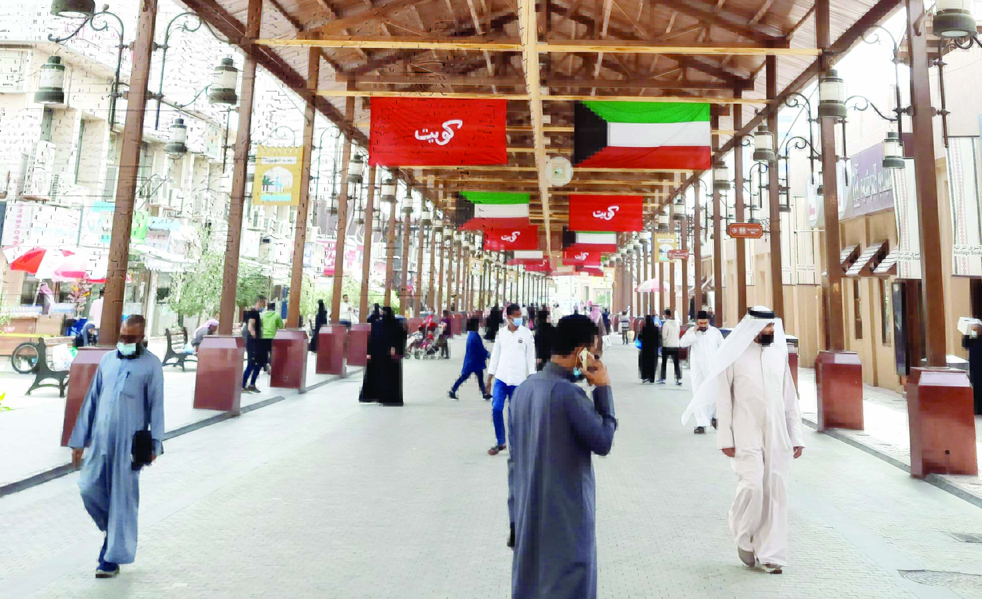 KUWAIT: People walk in Kuwait City's traditional Souq Mubarakiya, which has been decorated in celebration of the country's national holidays. - Photos by Fouad Al-Shaikhn