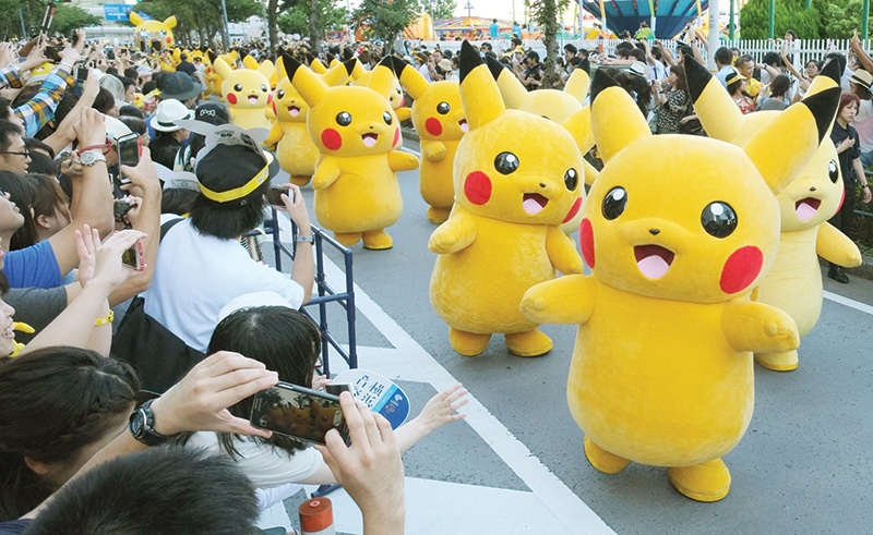 YOKOHAMA: In this file photo taken on Aug 7, 2016, performers dressed as Pikachu, the popular animation Pokemon series character, perform in the Pikachu parade. — AFP  rn