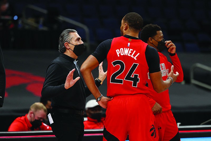 TAMPA: Acting Head Coach Sergio Scariolo and Norman Powell #24 of the Toronto Raptors talk during the game against the Houston Rockets on Friday at Amalie Arena in Tampa, Florida. — AFP